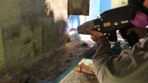 Operator ablates on a bridge wall