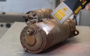 A laser ablates on a metal part for a nuclear decontamination application